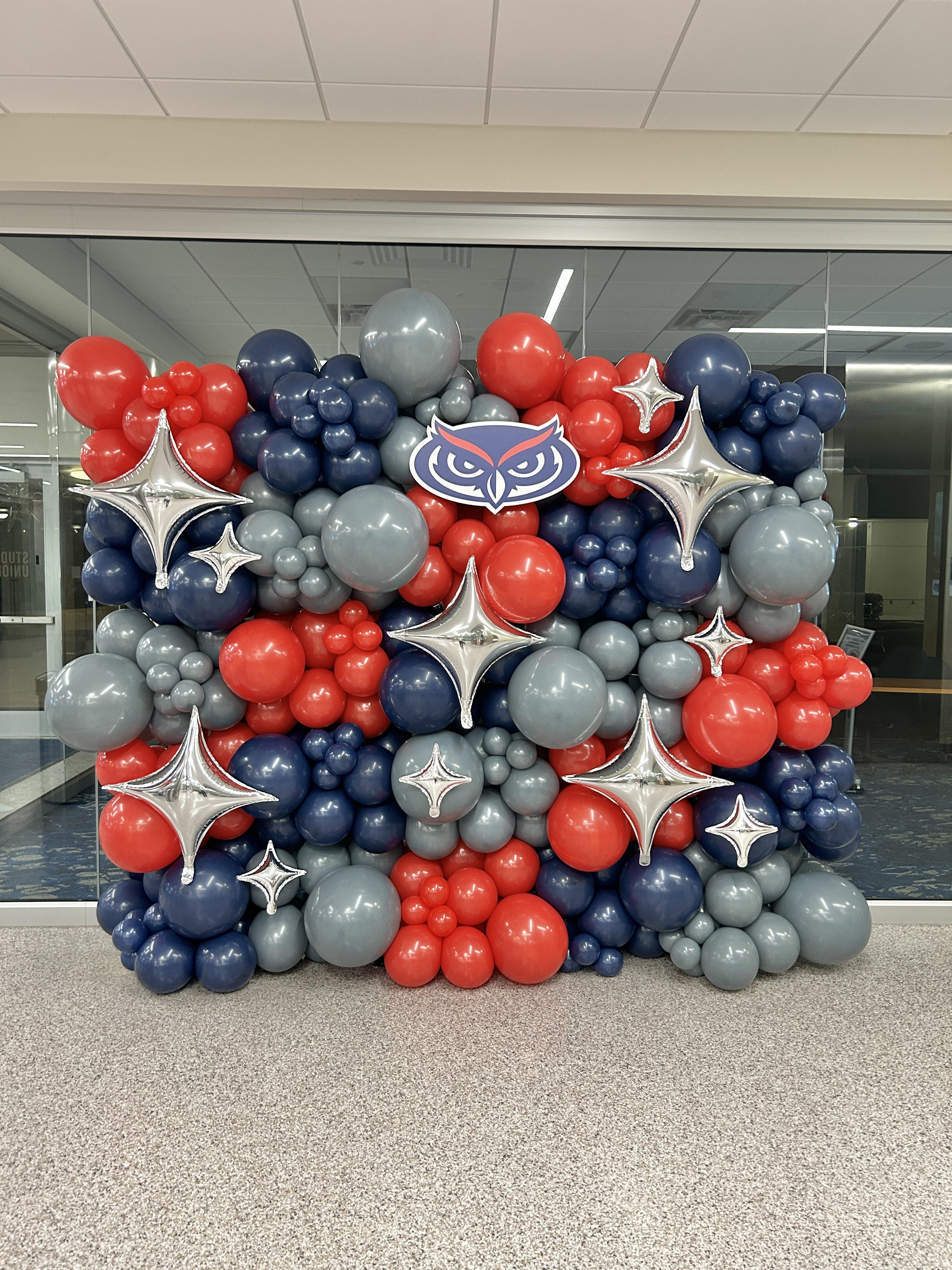 FAU branded balloon wall installation with silver star accents